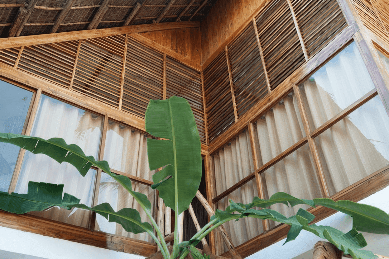 Dorms exterior view with wooden structure and banana leaves