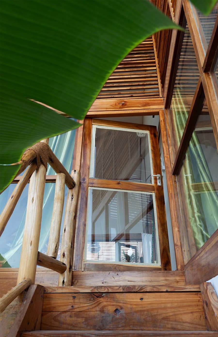 Window and stairs detail with banana leaf