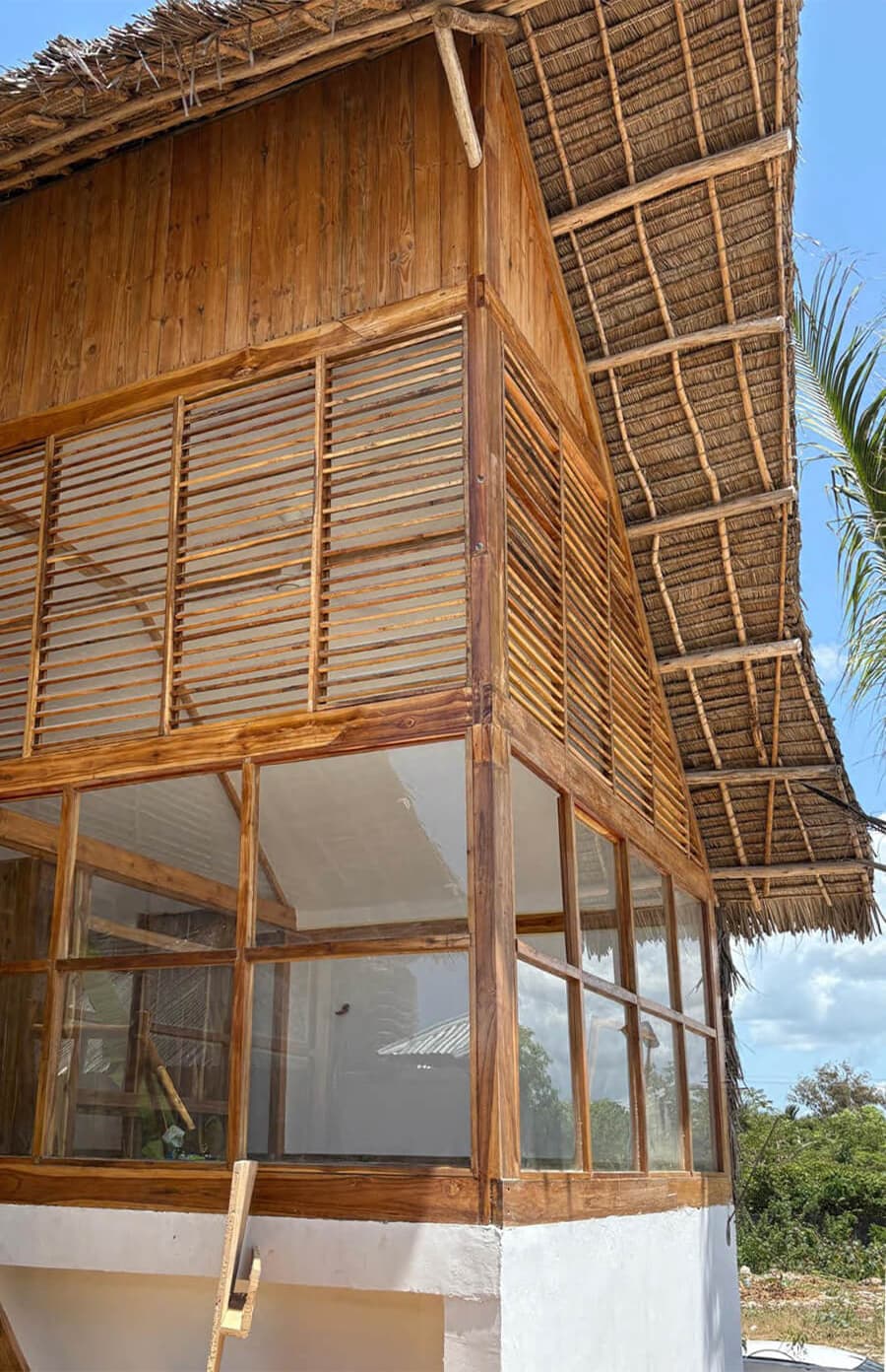 Full exterior view with thatched roof