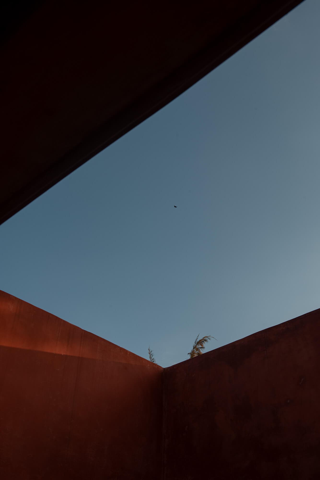 Villa DC courtyard walls framing the evening sky
